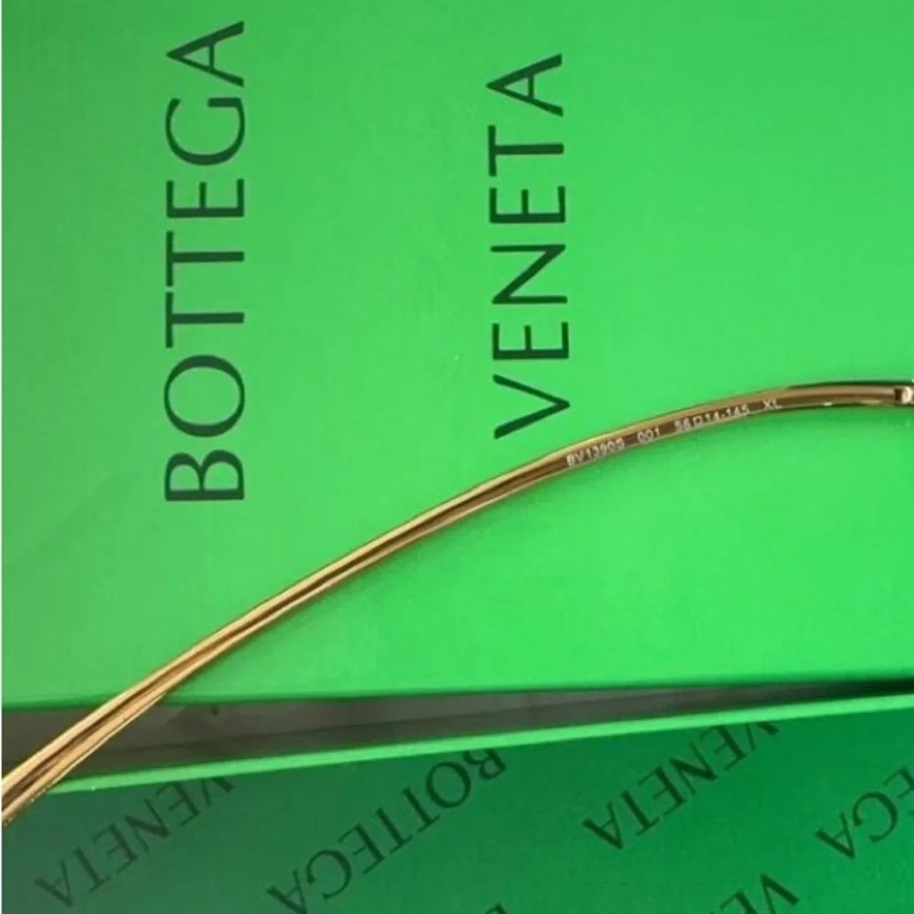 Bottega Veneta Black Frame Sunglasses with Amber Lenses and Gold Details